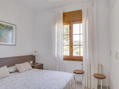 a white bedroom with a bed and a window at Villa in Arenys de Mar with Sea View in Arenys de Mar