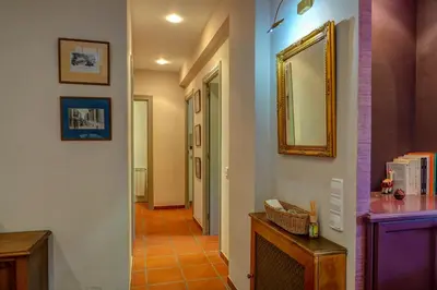 a hallway with a mirror on the wall and a hallway with a hallway at Montroig Zen Penthouse by Hello Homes Sitges in Sitges