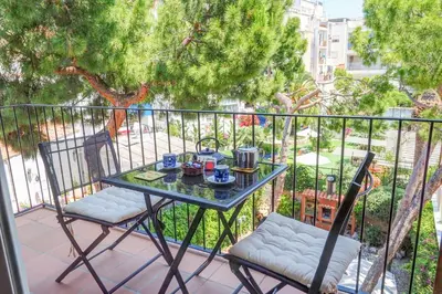 a table and two chairs sitting on a balcony at Montroig Zen Penthouse by Hello Homes Sitges in Sitges