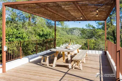 a villa with a swimming pool and a house at Villa Falco is a beautiful single storey holiday villa with private pool in Viladellops