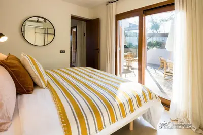 a living room with a couch and a table at Villa Falco is a beautiful single storey holiday villa with private pool in Viladellops