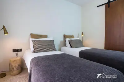 a white bed in a room with a window at Villa Falco is a beautiful single storey holiday villa with private pool in Viladellops