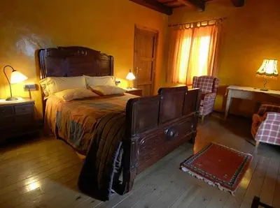 a bedroom with a large wooden bed in a room at El Folló Turisme Rural in Tagamanent