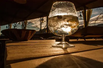 a glass of water sitting on top of a table at El Folló Turisme Rural in Tagamanent