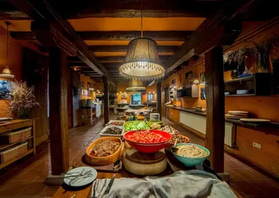 a buffet line with bowls of food in a kitchen at El Folló Turisme Rural in Tagamanent