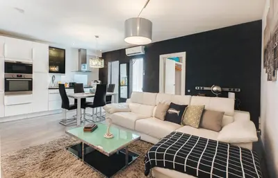 a living room with a white couch and a table at Stay Unique Apartments Aprestadora in Hospitalet de Llobregat