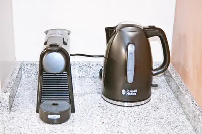 a tea kettle and a toaster on a counter at Urban Manesa city center apartment with private patio in Manresa