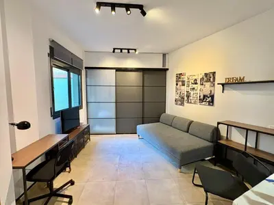 a living room with a couch and a table at Urban Manesa city center apartment with private patio in Manresa