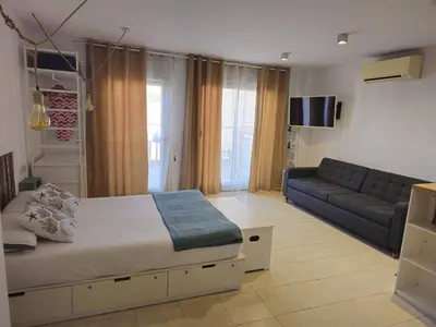 a living room with a bed and a couch at Mataró Center Apartment in Mataró