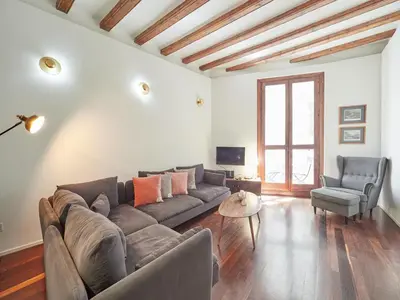 a living room with a couch and two chairs at BarcelonaForRent Alessandra Ramblas in Barcelona