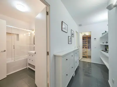 a white bathroom with a shower and a walk in closet at BarcelonaForRent Alessandra Ramblas in Barcelona