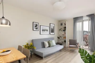 a living room with a couch and a table at Casa Cosi - Sants in Barcelona