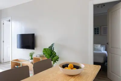 a room with a table with a bowl of fruit on it at Casa Cosi - Sants in Barcelona