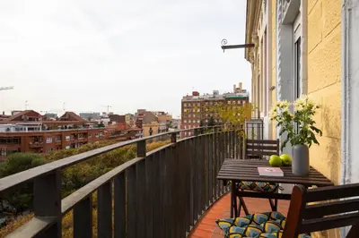 a balcony with a table and chairs on a balcony at Casa Cosi - Sants in Barcelona