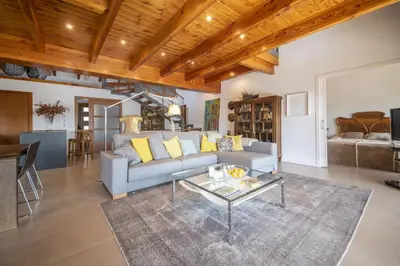 a living room with a couch and a table at Catalunya Casas Infinity pool and views 20min to Barcelona in Torrelles de Llobregat
