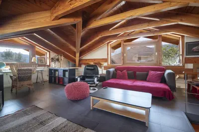 a living room with a red couch and a table at Catalunya Casas Infinity pool and views 20min to Barcelona in Torrelles de Llobregat