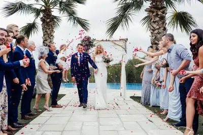 a bride and groom walking down the aisle after their wedding ceremony at Casa Nova Estate in Sitges