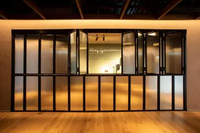 a room with a glass door with a wooden floor at Hotel Paxton Barcelona in Barcelona
