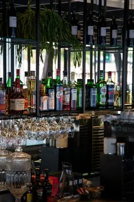 a bar with a bunch of glasses and bottles of alcohol at Hotel Paxton Barcelona in Barcelona