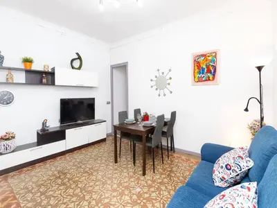 a living room with a blue couch and a table at Apartment Gracia- Providencia by Interhome in Barcelona