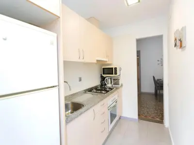 a small kitchen with a sink and a microwave at Apartment Gracia- Providencia by Interhome in Barcelona