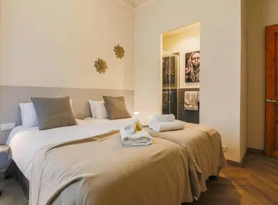 a bedroom with two beds with towels on them at Avinyo 2 Gotic · Spacious Loft in Gothic Quarter! in Barcelona
