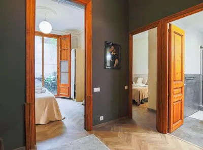 a hallway with a room with a bed and a mirror at Avinyo 2 Gotic · Spacious Loft in Gothic Quarter! in Barcelona