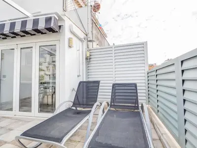 a pair of chairs sitting on a balcony at Blue Serenity by Hello Homes Sitges in Sitges