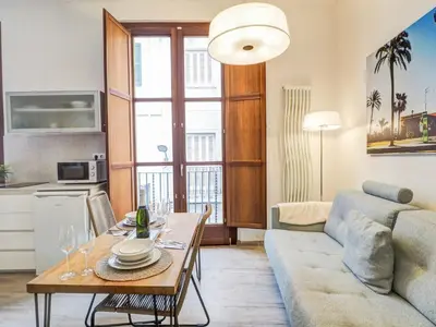 a living room with a couch and a table at The Green Oasis by Hello Homes Sitges in Sitges