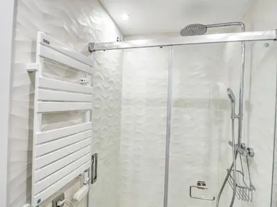 a shower with a glass door in a bathroom at The Green Oasis by Hello Homes Sitges in Sitges