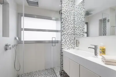 a white bathroom with a shower and a sink at HHBCN Beach Apartment Gava #2 in Gavà