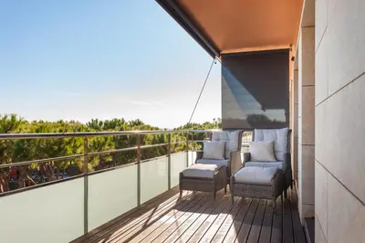 a balcony with chairs and a view of the ocean at HHBCN Beach Apartment Gava #2 in Gavà