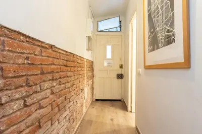 a brick hallway with a door and a brick wall at Housalia Sagrada Familia in Barcelona