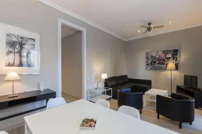 a living room with a couch and a table and chairs at Housalia Sagrada Familia in Barcelona