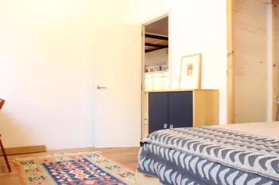 a wooden table and chairs in a room with windows at Apartment Graus Barcelona in Barcelona