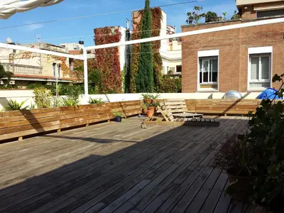a garden with potted plants and a grill at Apartment Graus Barcelona in Barcelona