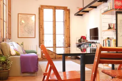 a living room with a table and a couch at Apartment Graus Barcelona in Barcelona