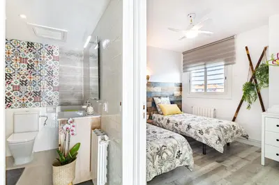 a small bedroom with two beds and a bathroom at LIANA SEAVIEW & BEACH - apartment in Montgat