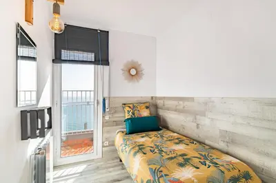 a bedroom with a bed and a window at LIANA SEAVIEW & BEACH - apartment in Montgat