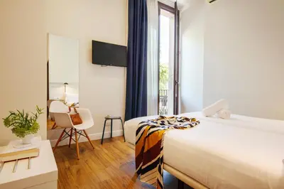 a hotel room with a bed and a window at Som Nit Born in Barcelona