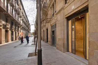 a street with people walking down the street at Som Nit Born in Barcelona