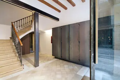a hallway with a staircase and a wooden wall at Som Nit Born in Barcelona