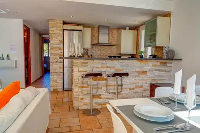 a kitchen and living room with a couch and a table at La Marina Sea Front by Hello Homes Sitges in Sitges