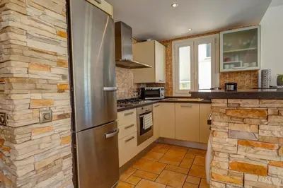 a kitchen with a stainless steel refrigerator at La Marina Sea Front by Hello Homes Sitges in Sitges