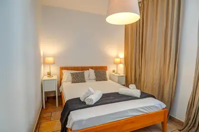 a bedroom with a bed with two pillows on it at La Marina Sea Front by Hello Homes Sitges in Sitges