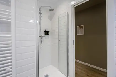 a shower with a glass door in a bathroom at Ola Living Diagonal II Apartments in Barcelona