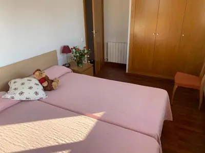 a bedroom with a bed with a teddy bear on it at Villa Dacar in Cubelles
