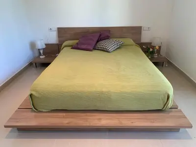 a large bed in a bedroom with two night stands at Villa Dacar in Cubelles