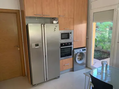 a kitchen with a stainless steel refrigerator and a dishwasher at Villa Dacar in Cubelles