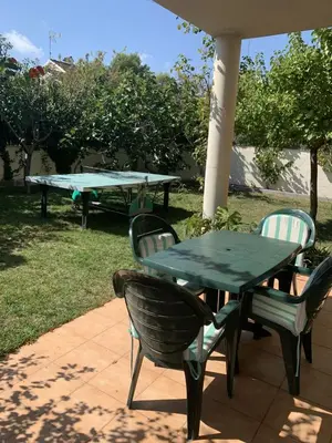 a green table and chairs and a table and a table and chairs at Villa Dacar in Cubelles
